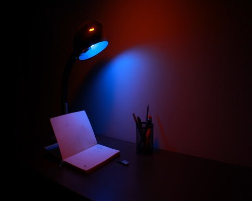 work desk with soft light and a notebook